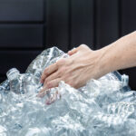 femals hands grabbing plastic bottles collect trash them